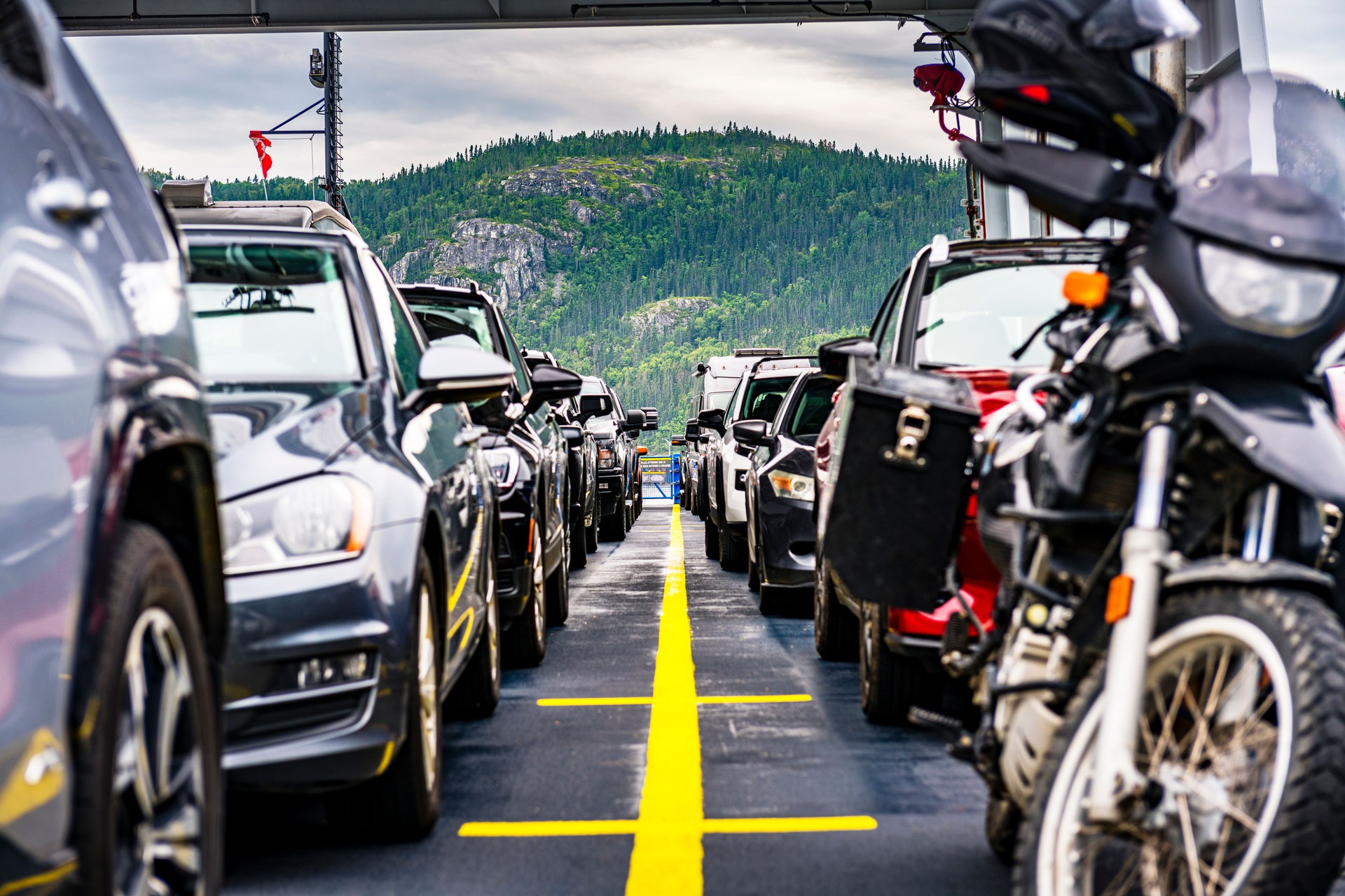 cars and motorbikes on a ferry over Saguenay Fjord in Canada