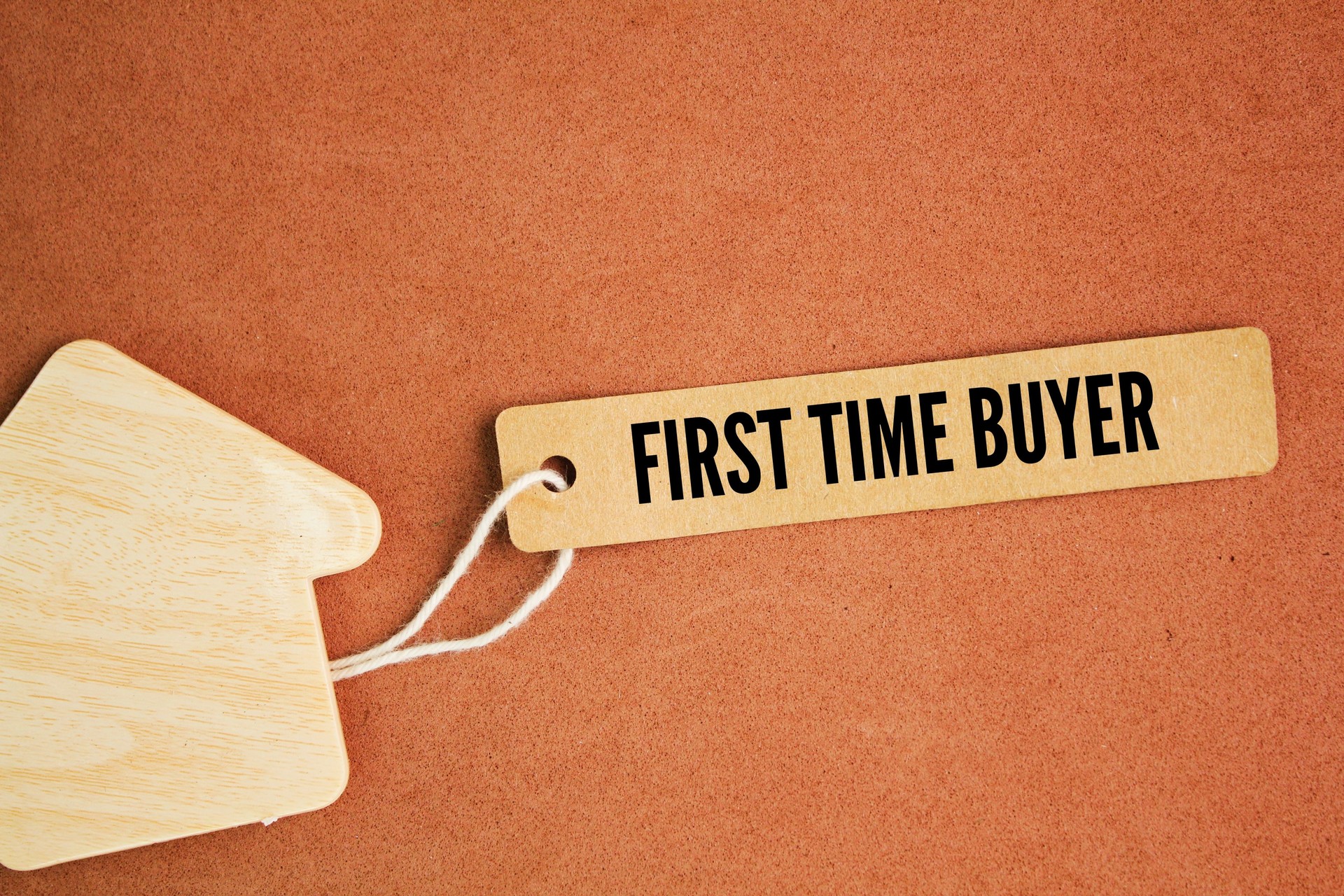 house shape and tag with the word first time buyer. a person buying a house or flat who has not previously owned a home and therefore has no property to sell