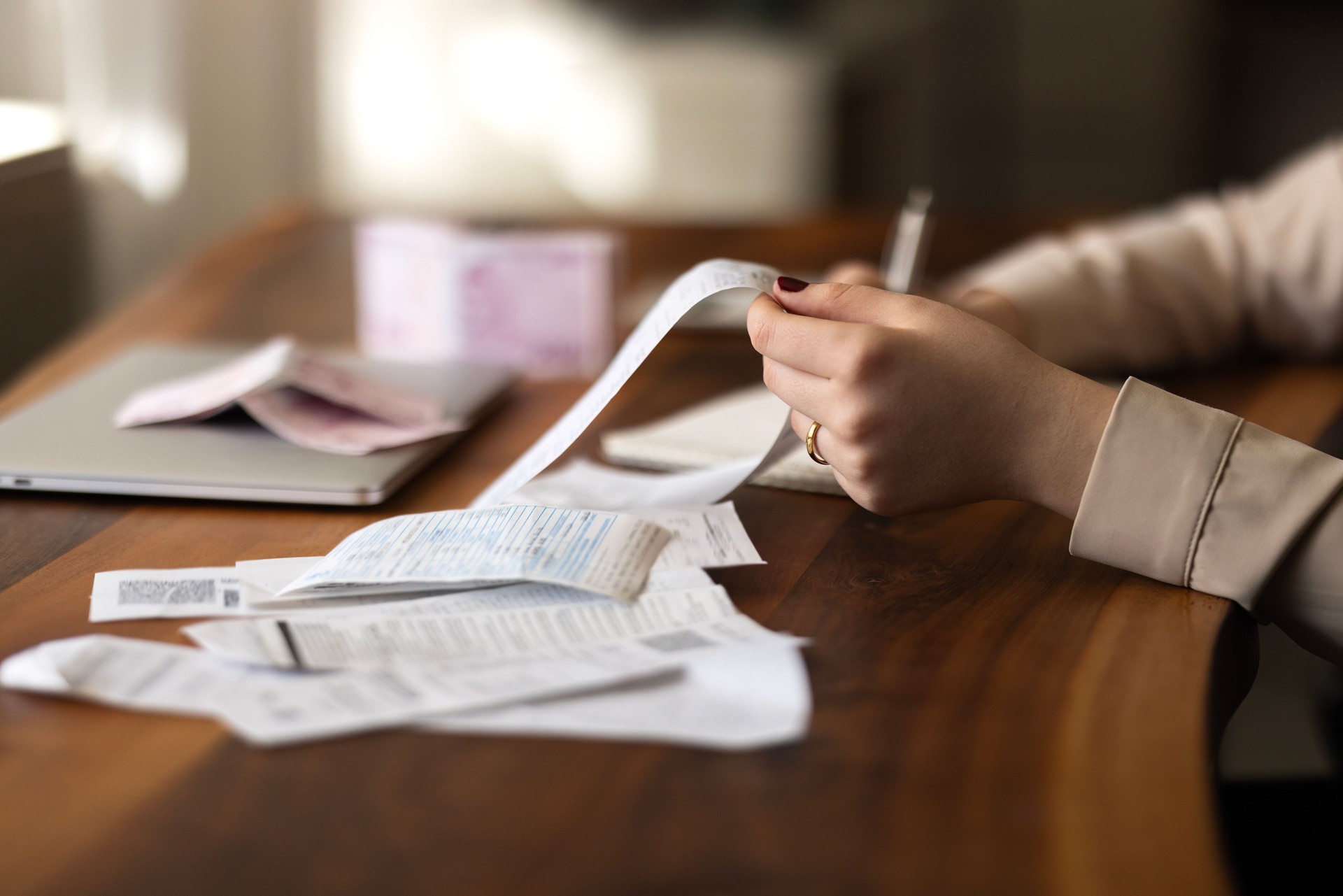 Woman is calculating the cost of the bill.